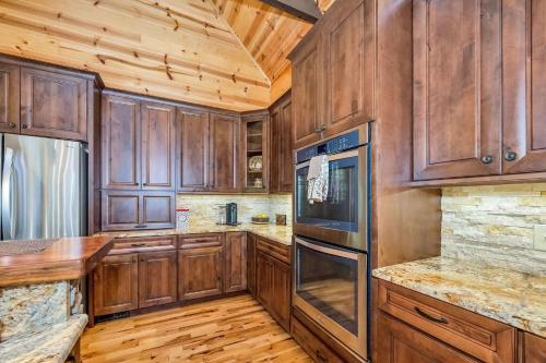 a kitchen with wooden cabinets and a wooden floor at Our Place to Paws 4 Bd Lux Blue Ridge Mnt Cabin in Lansing