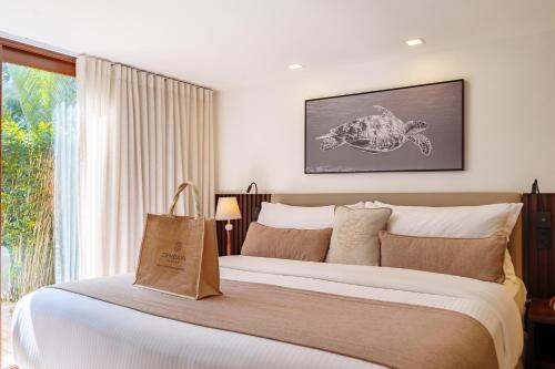 a bedroom with a large bed and a window at Zendaya Resort Beach Sport & Spa in Búzios
