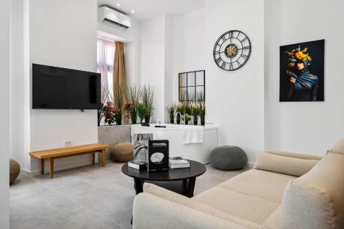 a living room with a couch and a tv at Joy Social Apartment in Bucharest