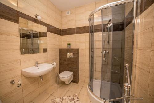 a bathroom with a sink toilet and a shower at Apartament Żaglowy nr 3 4os in Puck