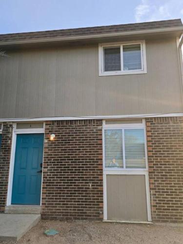 a brick house with blue doors and windows at All New! Convenient Location! Sleeps 6 in Denver