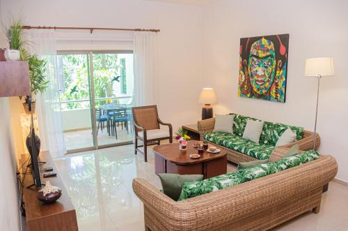 a living room with a couch and a table at Palmar del Sol by Riviera Maya Suites in Playa del Carmen