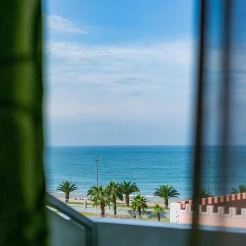 a view of the ocean from a window at Orbi City Superhost in Batumi