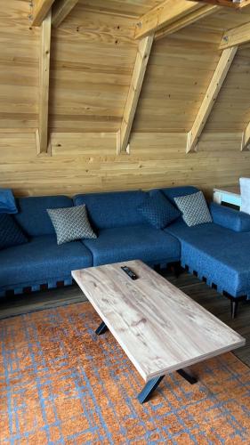 a living room with a couch and a wooden table at Villat Liss in Peje