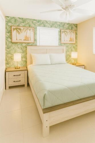 a bedroom with a large bed and two night stands at Charming 1BR Canal Front Retreat in Naples