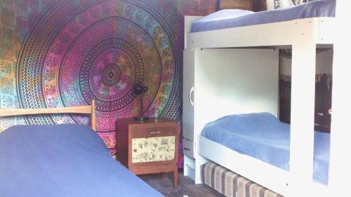 a bedroom with two bunk beds and a colorful wall at Mama Killa Neptunia Eco hostel in Salinas 