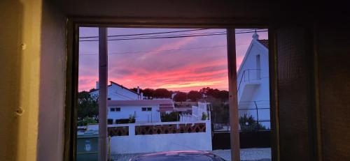 a view of a sunset from a window at MIX inn in Vendas Novas