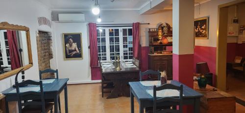 a room with two tables and a desk in it at MIX inn in Vendas Novas
