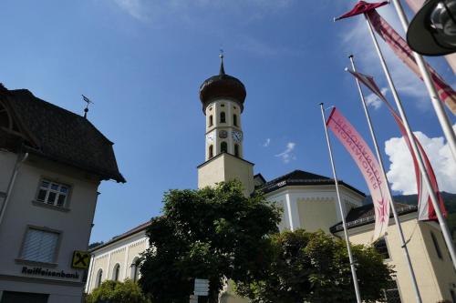 a building with a clock tower on top of it at Apartment Sonnenlicht in Schruns-Tschagguns