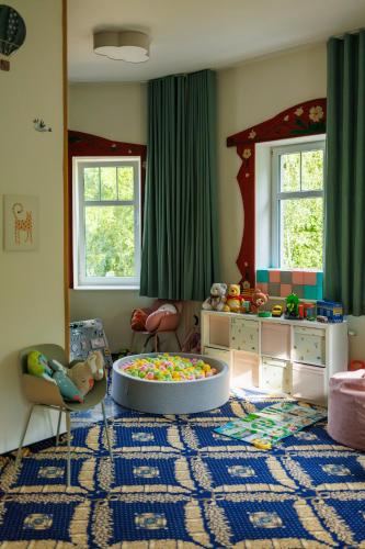 a childs room with a play area with a toy table at St Lukas Medical & SPA in Świeradów-Zdrój