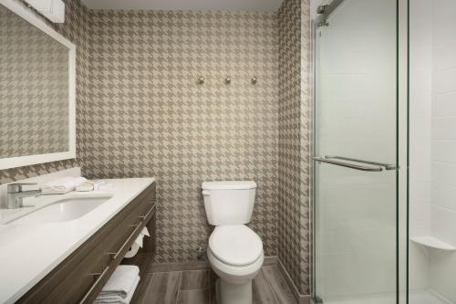 a bathroom with a toilet and a sink and a shower at Home2 Suites By Hilton Weston Ft. Lauderdale in Davie