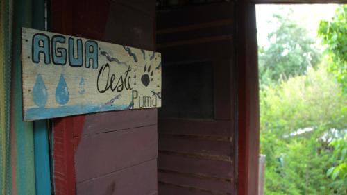 a sign on the side of a building at Mama Killa Neptunia Eco hostel in Salinas 