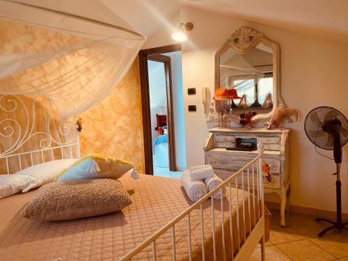 a bedroom with a bed with a mirror and a dresser at Villa Alloggio Cupido comfort-Relax in Pianezza