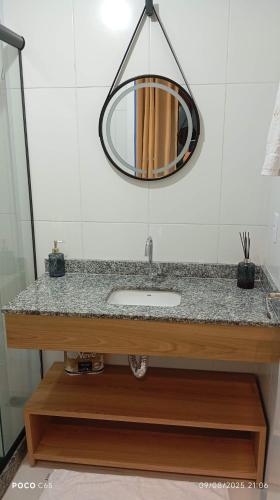 a bathroom with a sink and a mirror at Studio com vista espetacular! in Niterói