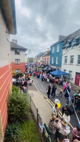 a crowd of people standing on a street with buildings at Cosy apartment in heart of Cork City in Cork