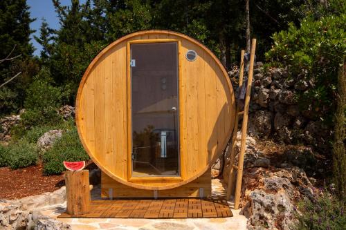 a small wooden boat sitting on a pile of rocks at Boo Premium Living Villas in Tsoukaladhes