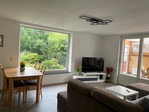 a living room with a couch and a table at Ferienwohnung am Uniklinik Lübeck in Lübeck