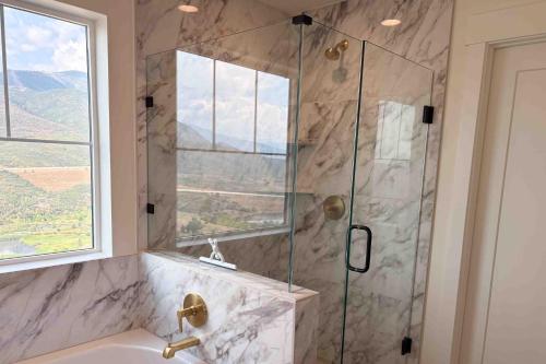 a bathroom with a shower with a glass door at The Views at Jordanelle Ridge in Cranmer