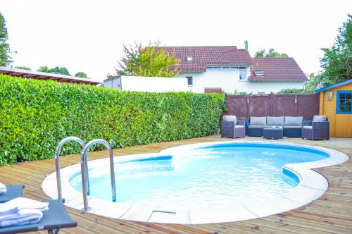 a small swimming pool on a wooden deck at Wellness & Fun am Bodensee - mit Pool, Kino, Tischkicker und Terrasse in Markdorf