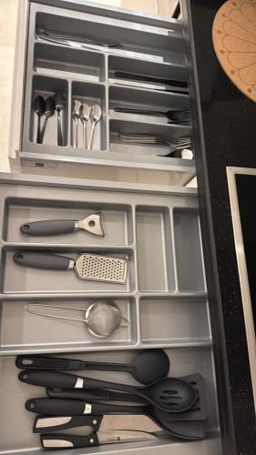 a drawer filled with lots of kitchen utensils at One way flat in Muscat
