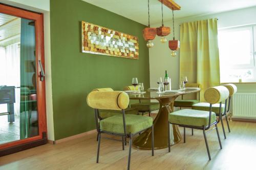 a dining room with a table and chairs at Wellness & Fun am Bodensee - mit Pool, Kino, Tischkicker und Terrasse in Markdorf