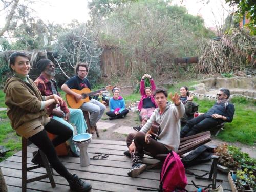 a group of people sitting on a wooden deck at Mama Killa Neptunia Eco hostel in Salinas 
