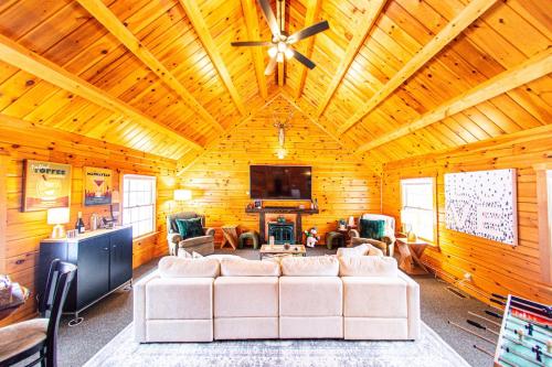 a living room with a white couch and a ceiling at Log Home w Mountain Views Near Windham & Hunter Ski Resorts in Maplecrest