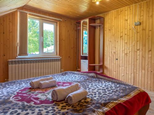 a bedroom with a large bed with towels on it at Садиба "Ековид" in Krivorovnya