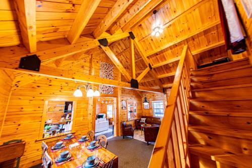 a dining room with a table in a wooden cabin at Log Home w Mountain Views Near Windham & Hunter Ski Resorts in Maplecrest