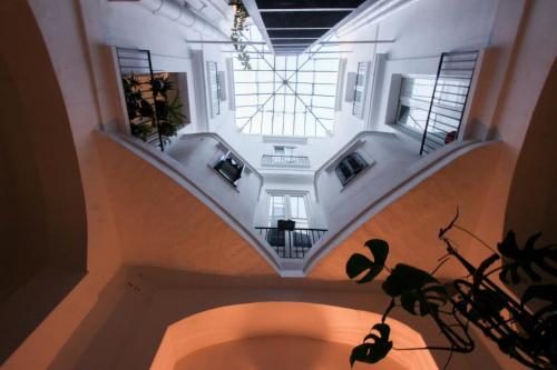 a room with a spiral staircase in a building at Loft57 L&G - Centro storico in Bari