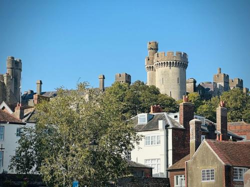 a group of chimneys on top of roofs of houses at River cottage Arundel in Arundel