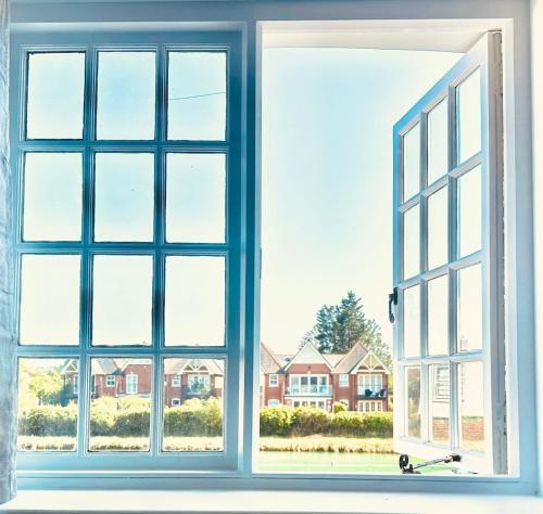 an open window with a view of a house at River cottage Arundel in Arundel