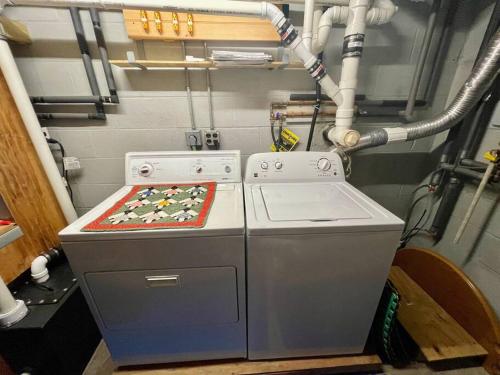 a washer and dryer in a room with pipes at Log Home w Mountain Views Near Windham & Hunter Ski Resorts in Maplecrest