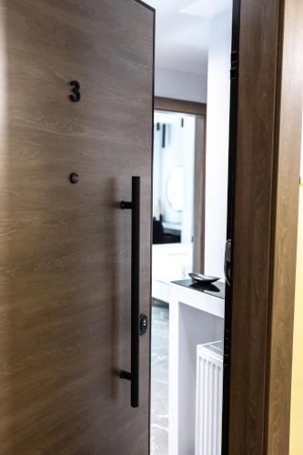 a wooden door in a room with a kitchen at LP Citycenter Suite 2 in Serres