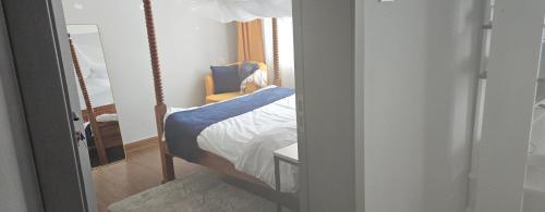 a bedroom with a bed and a mirror at Chichi homes sabaki residents in Nairobi