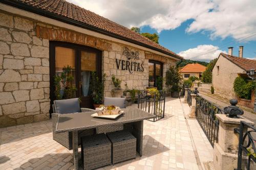 a patio with a table and chairs in front of a building at Veritas in Tokaj