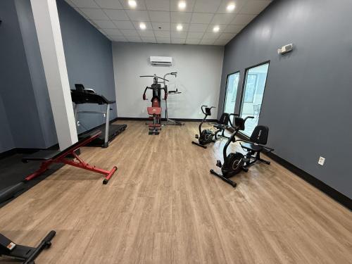 a gym with several exercise bikes in a room at HomeTowne Studios by Red Roof Flint in Flint