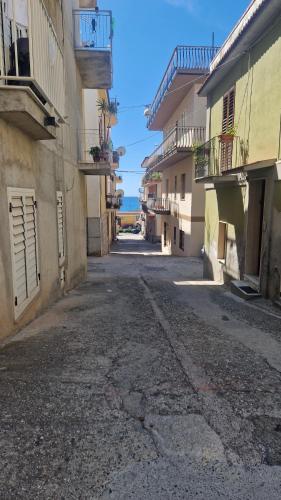 an empty street in an alley between two buildings at civico 44 in Bova Marina