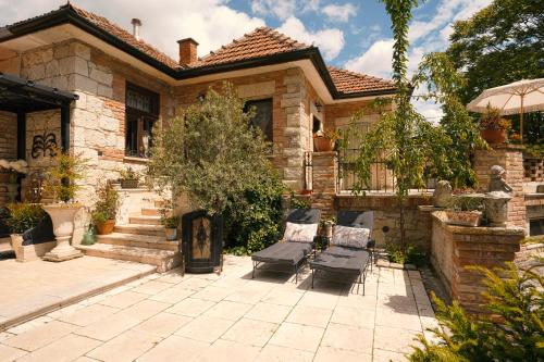 a house with a patio with two chairs in the yard at Veritas in Tokaj