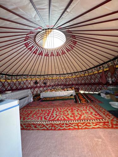 a large room with a large rug in a yurt at Home in Tosor, Kyrgyzstan in Tossor