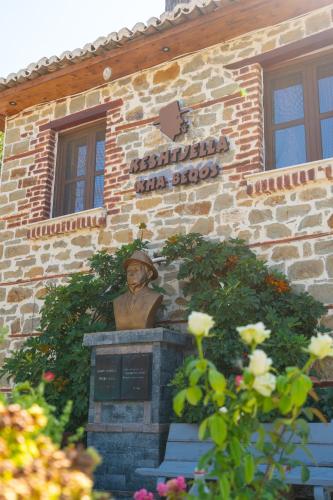 a building with a statue in front of it at Keshtjella Xhabeqos in Tirana