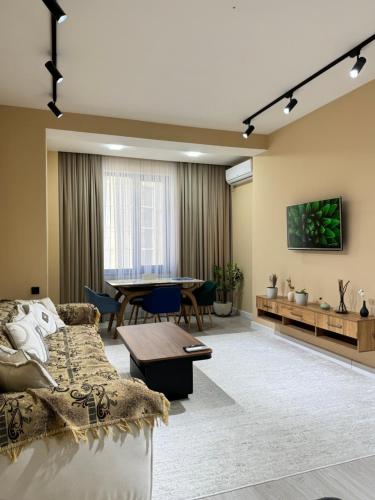 a living room with a couch and a table at Serenity in Dushanbe