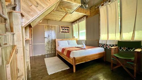 a bedroom with a bed with a laptop on it at Saadani Beach Camp in Saadani