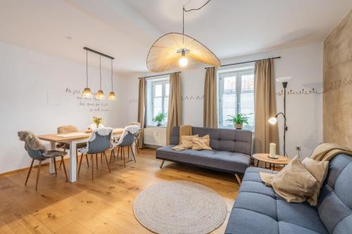 a living room with a blue couch and a table at Die große Hoamat in Gröbming