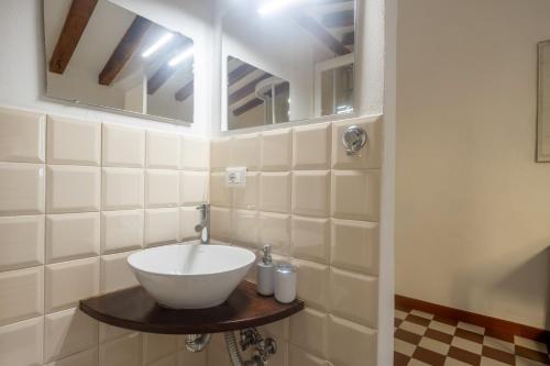 a bathroom with a sink and two mirrors at Matteotti 45 in Sarzana