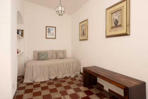 a bedroom with a bed and a table in it at Matteotti 45 in Sarzana