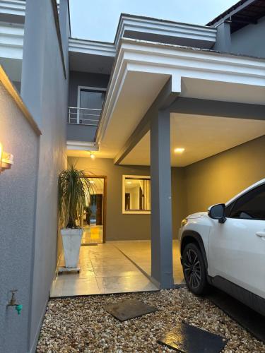a white car parked in front of a house at Casa Joinville in Joinville
