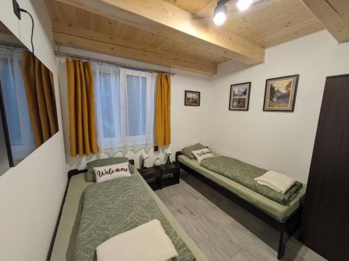 a room with two beds and a window at Apartmány U Lazara in Kutná Hora
