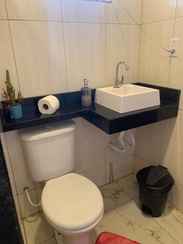 a bathroom with a white toilet and a sink at Luxury caiçara house in Paraty in Paraty