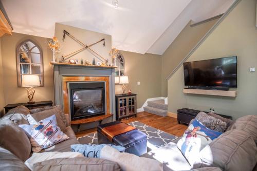 a living room with two couches and a fireplace at Finley Lodge in Cooks Crossing